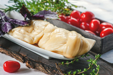 Delicate white fibrous farm cheese Cecil with tomatoes and Basil. Russian farm cheese. Natural product