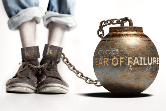 Fear of failure can be a big weight and a burden with negative influence - Fear of failure role and impact symbolized by a heavy prisoner's weight attached to a person, 3d illustration