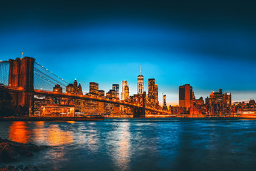 Fototapeta na wymiar New York night view of the Lower Manhattan and the Brooklyn Bridge across the East River.