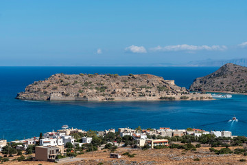 Fototapeta na wymiar Spinalonga Island, northern Crete, Greece, October 2019. The former leper colony of Spinalonga Island viewed fron the coastal town of Plaka,