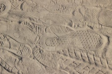 Footprints and markings on sand dirt background