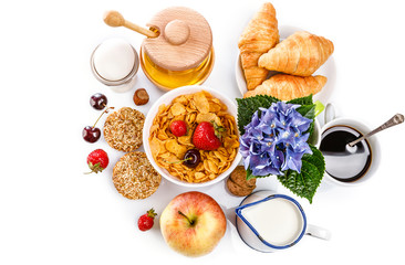 Breakfast fresh croissant coffee berry and honey. Still life of sweets and fruits top view, isolated white background.