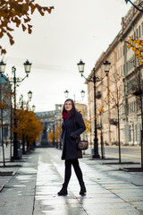 brunette girl walking along the street of St. Petersburg in the city center.