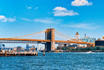 Fototapeta na wymiar Suspended Brooklyn Bridge across the East River between the Lower Manhattan and Brooklyn.