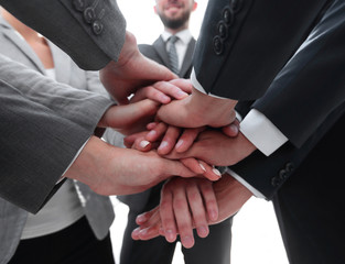 business people folding their hands together.