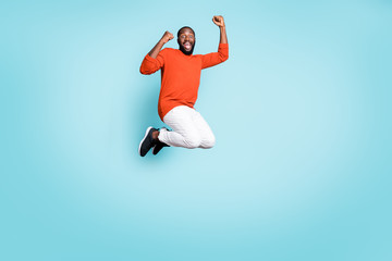 Fototapeta na wymiar Full length body size photo of overjoyed crazy rejoicing black man wearing white mixed-race jump trousers pants sneakers expressing emotions on face isolated vivid blue color background