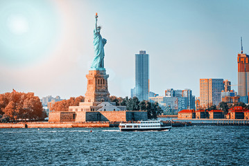 Statue of Liberty on Liberty Island on the background New York Harbor and New York City. - obrazy, fototapety, plakaty