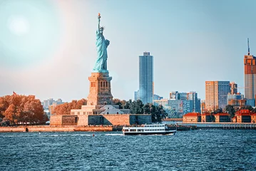 Fotobehang Statue of Liberty on Liberty Island on the background New York Harbor and New York City. © BRIAN_KINNEY