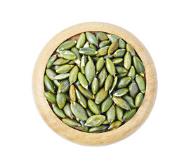 Dired pumpkin seeds i  wooden dish.
