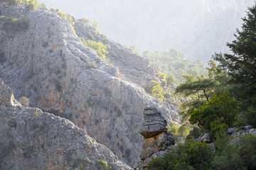 slope of mountain canyon in a mist and early morning light, natural mountain background