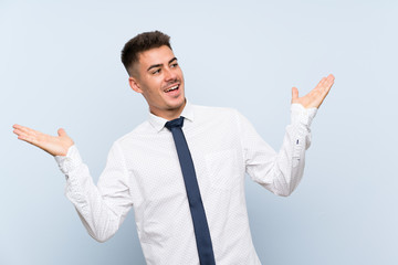 Handsome businessman over isolated blue background with surprise facial expression