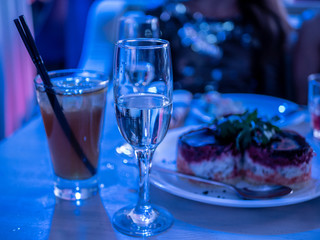 Traditional new year celebration meal of russian table herring salad is on table near glasses of champagne and cocktail