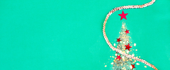 Banner for the site with a Christmas tree from sparkles and confetti.