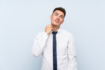 Handsome businessman over isolated blue background thinking an idea