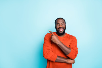 Photo of attractive dark skin business guy toothy smiling indicating finger to empty space advising...