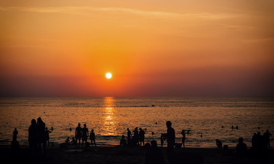 Fototapeta na wymiar Silhouettes of people over sea background at sunset. Thailand, Phuket, Karon Beach