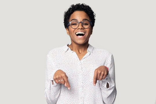 Head Shot Excited African American Girl In Glasses Pointing Down