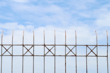 Steel fence on the sky background, security or forbidden boundary area zone