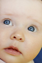 Little baby close up face. Newborn looking