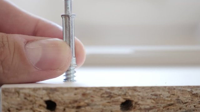 Slow motion holding screw and driving it through the hole 1080p footage