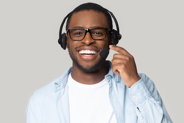 Head shot smiling African American support service operator in headphones