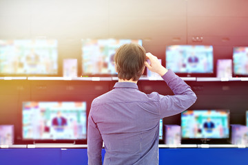 Man looks at TV in store