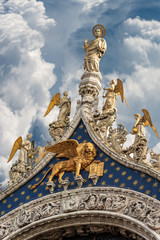Fototapeta na wymiar Venice, detail of the Basilica of San Marco with the statue of St Mark the evangelist, golden winged lion and angels. UNESCO world heritage site, Veneto, Italy, Europe