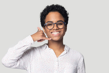 Head shot smiling African American woman showing call me gesture