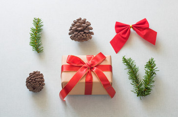 Christmas background with gift boxes, pine cone and decorations on light blue background. Preparation for holidays. Top view with copy space.