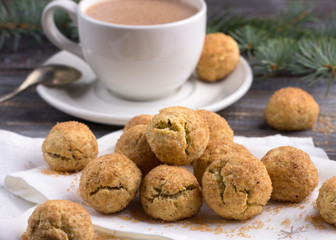 Freshly baked snickerdoodle cookies with cinnamon and nuts, hot chocolate on wooden background	