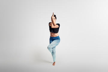 Eagle pose,  yoga pose, woman on white background, frontal 