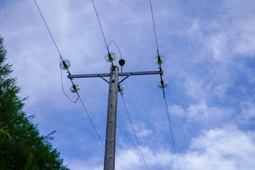 Electrical power pole with a blue sky background