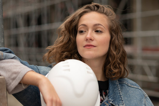 Work break on construction site: thoughtful and contemplative factory female employee resting - Powered by Adobe