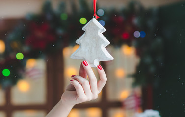 female hand hanging christmas decoration