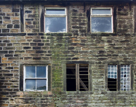 broken windows in an old derelict stone house