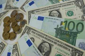 Banknotes of 100 euros and 1 dollar, paper money and coins, background
