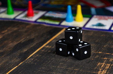 three black dice for a board game on the board