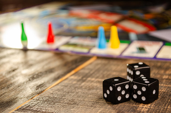 Board Game On A Black Wooden Background With A Sunbeam