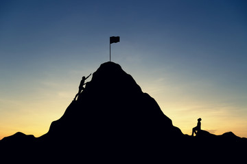 Silhouette of successful team and team that failed at sunset background.