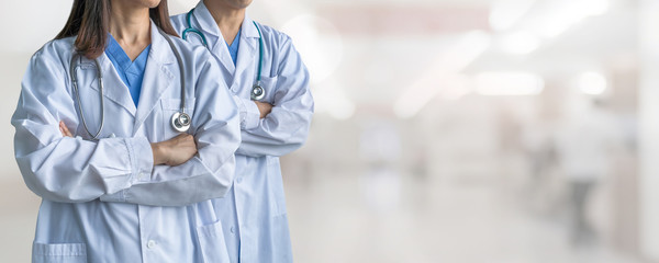 Surgeon and anesthetist doctor ER surgical team with medical clinic room background for emergency...