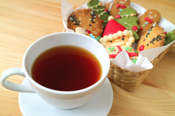 Closeup a Cup of Hot Tea with Blurry Basket of Christmas Cookies in the Backdrop 