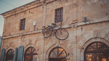 vintage bike hanging from wall at Xanthi city