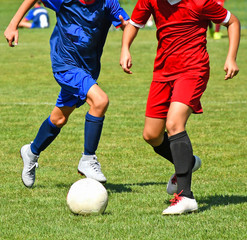 Fototapeta premium Young kids are playing soccer in summer time