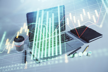 Forex graph hologram with desktop office computer background. Double exposure. Concept of financial...