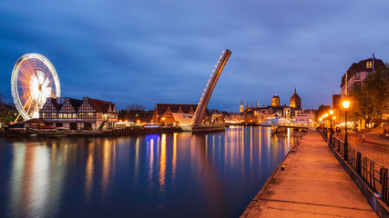 Amazing lights on cityscape of evening Gdansk, view from Wapienny Bridge on bascule footbridge.