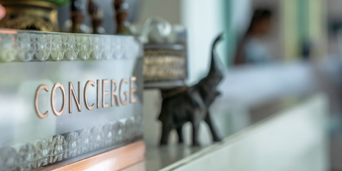 Concierge service counter of hotel, restaurant or apartment's front desk in luxury reception hall in Thailand with staff working for serving tourist guest or check-in customers