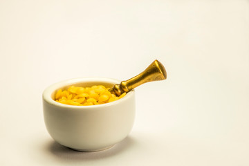 bee wax, closeup of the bee product in a mortar