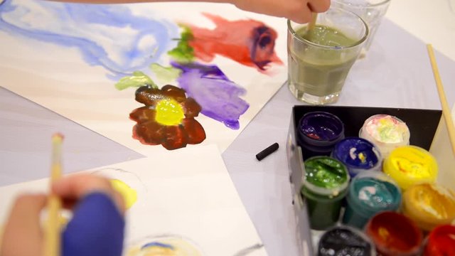 children paint flowers in watercolor