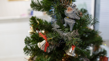Ornament on a Christmas tree with bells and Santa