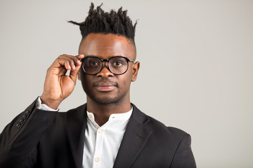 handsome young african man in black suit wearing glasses